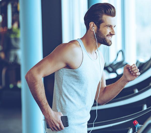 Happy man running on Walkslim treadmill